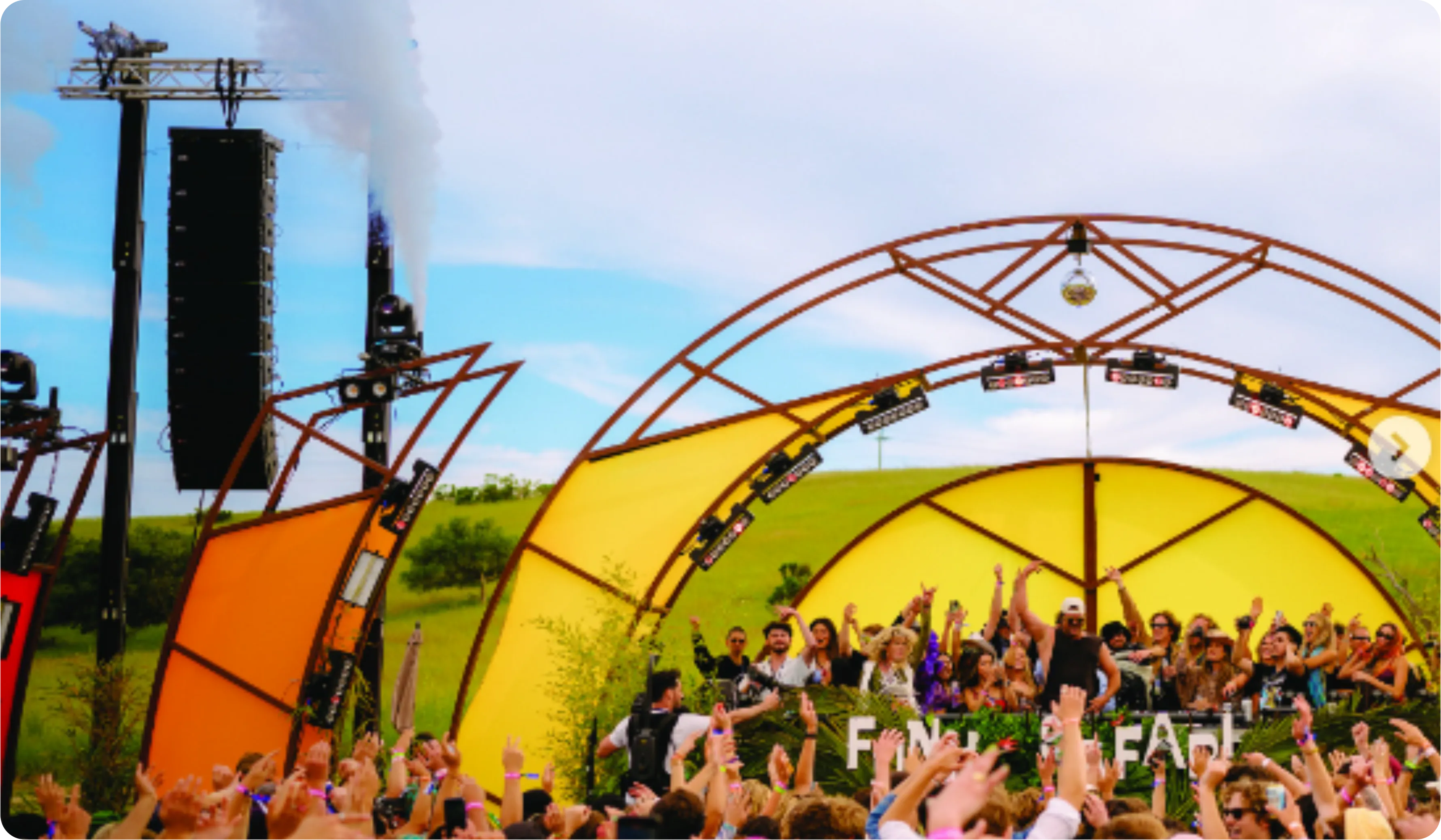 Festival crowd beneath a geodesic stage canopy